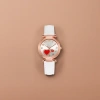 The watch features a white strap, rose gold case, silver dial and red heart decoration details Picture